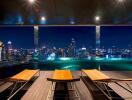 Rooftop swimming pool with city view at night