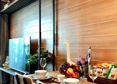 Dining area with a modern table setup, television, and air conditioner