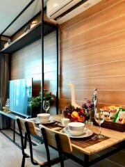 Dining area with a modern table setup, television, and air conditioner