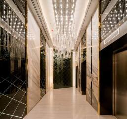 Elegant building corridor with modern lighting and elevator doors