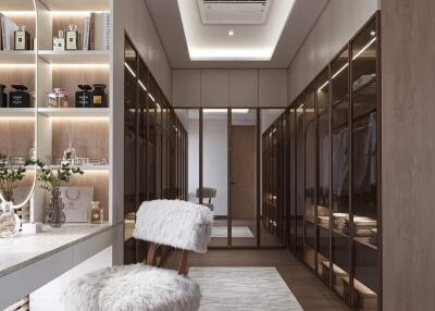 Luxurious walk-in closet with ample storage and a vanity area