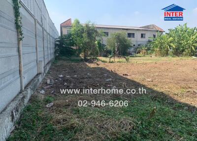 Vacant land with a building in the background