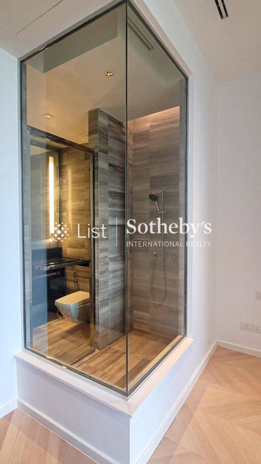 Modern glass-enclosed bathroom with shower