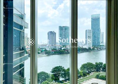 View from a high-rise building window over a river and cityscape