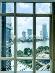 View from a high-rise building window over a river and cityscape