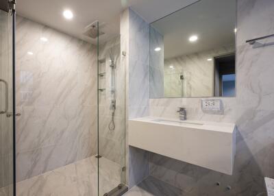 Modern bathroom with glass shower and wall-mounted sink