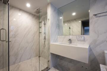 Modern bathroom with glass shower and wall-mounted sink