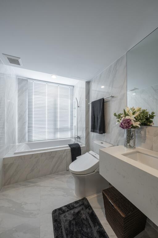 Modern bathroom with a bathtub, toilet, and sink