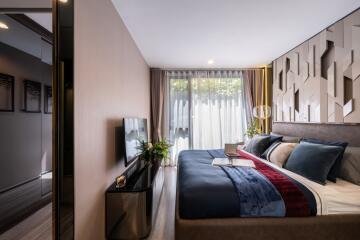 Modern bedroom with large bed and natural light