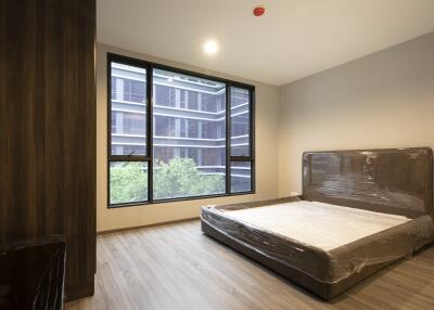 Modern bedroom with a large window and bed