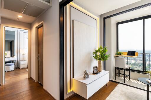 A modern apartment with a hallway leading to a home office and a balcony.