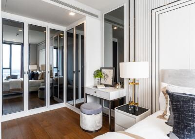 Modern and stylish bedroom with mirrored closets and a small desk