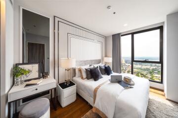 Modern bedroom with large window and city view