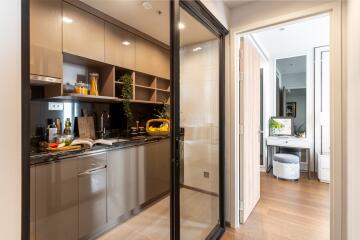 Modern kitchen with glass sliding door and view into hallway