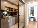 Modern kitchen with glass sliding door and view into hallway