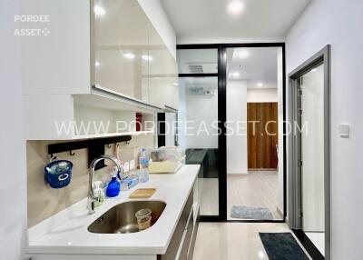 Modern kitchen with white cabinets and stainless steel sink