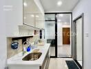 Modern kitchen with white cabinets and stainless steel sink