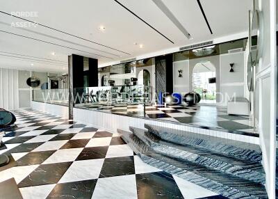 Modern atrium with checkered floor and elevated platform