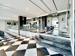 Modern atrium with checkered floor and elevated platform