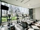 Bright and modern gym with exercise equipment and large windows