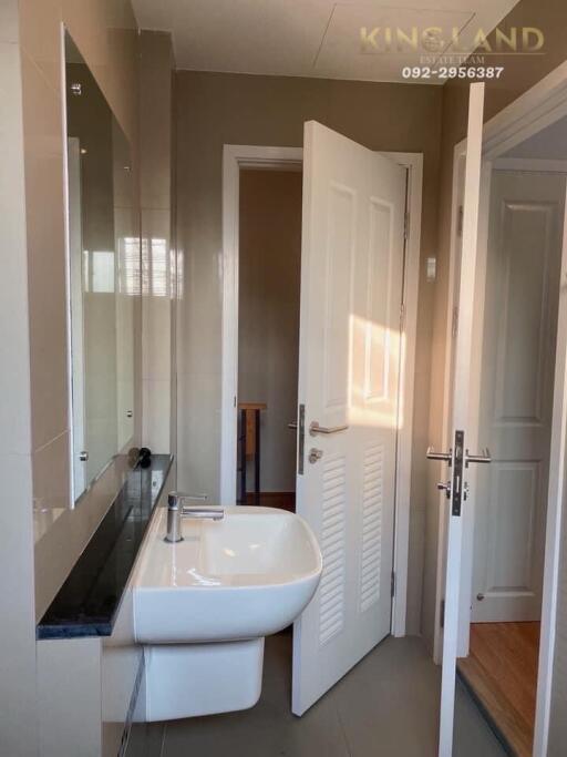 Well-lit bathroom with sink and mirror