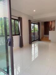 Spacious living room with large windows and sliding glass door