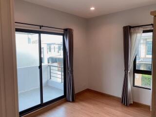 Modern bedroom with sliding glass doors and windows