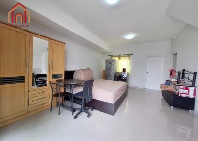 Spacious bedroom with wardrobe, bed, desk, and chair