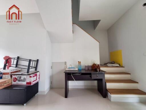 Stairway with desk and boxes in a room