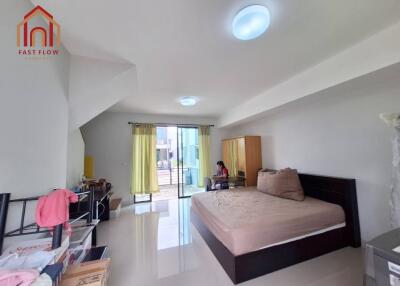 Spacious bedroom with large bed and balcony access