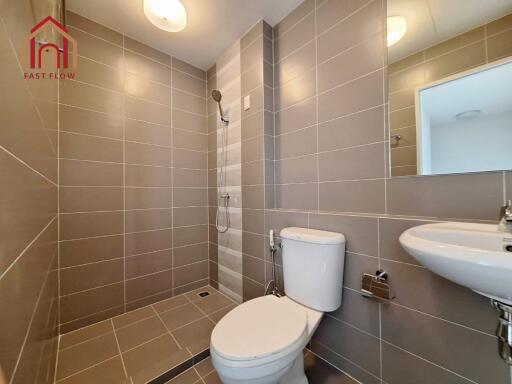 Modern bathroom with shower and neutral tiles