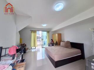 Spacious bedroom with large bed and access to balcony