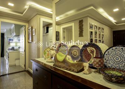 Decorated hallway with mirror and view into kitchen