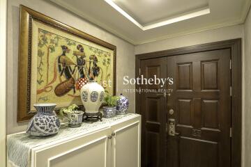 Decorated entryway with wooden door and artwork