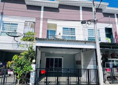 Exterior view of a modern townhouse with a garage and balcony