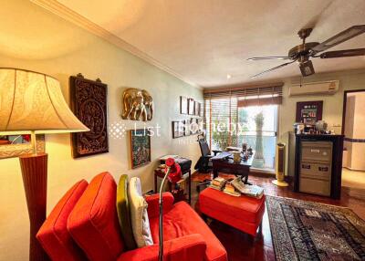 Cozy living room with red furniture and view of an outdoor space