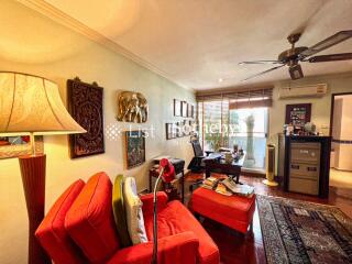 Cozy living room with red furniture and view of an outdoor space