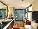 Spacious bathroom with modern amenities and blue-tiled shower area