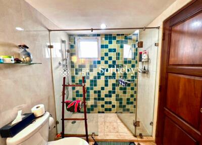 Modern bathroom with glass shower enclosure and mosaic tile design