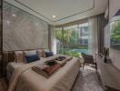 Modern bedroom with large windows and a view of a pool.