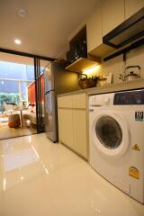 Modern kitchen with washing machine and dining area view