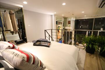 Bright bedroom with modern decor and mezzanine view