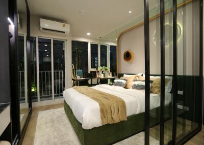 Modern bedroom with glass walls and balcony access