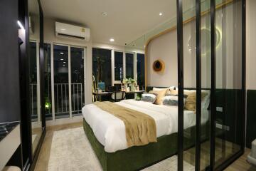 Modern bedroom with glass walls and balcony access