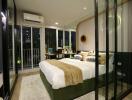 Modern bedroom with glass walls and balcony access