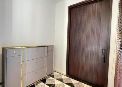 Modern entrance with patterned flooring and storage unit