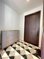 Modern entrance with patterned flooring and storage unit