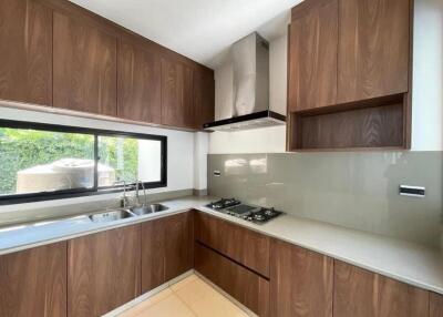 Modern kitchen with wooden cabinets and stainless steel appliances