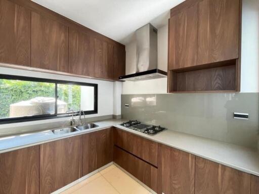 Modern kitchen with wooden cabinets and stainless steel appliances