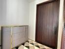 Entryway with geometric tile flooring and wooden door